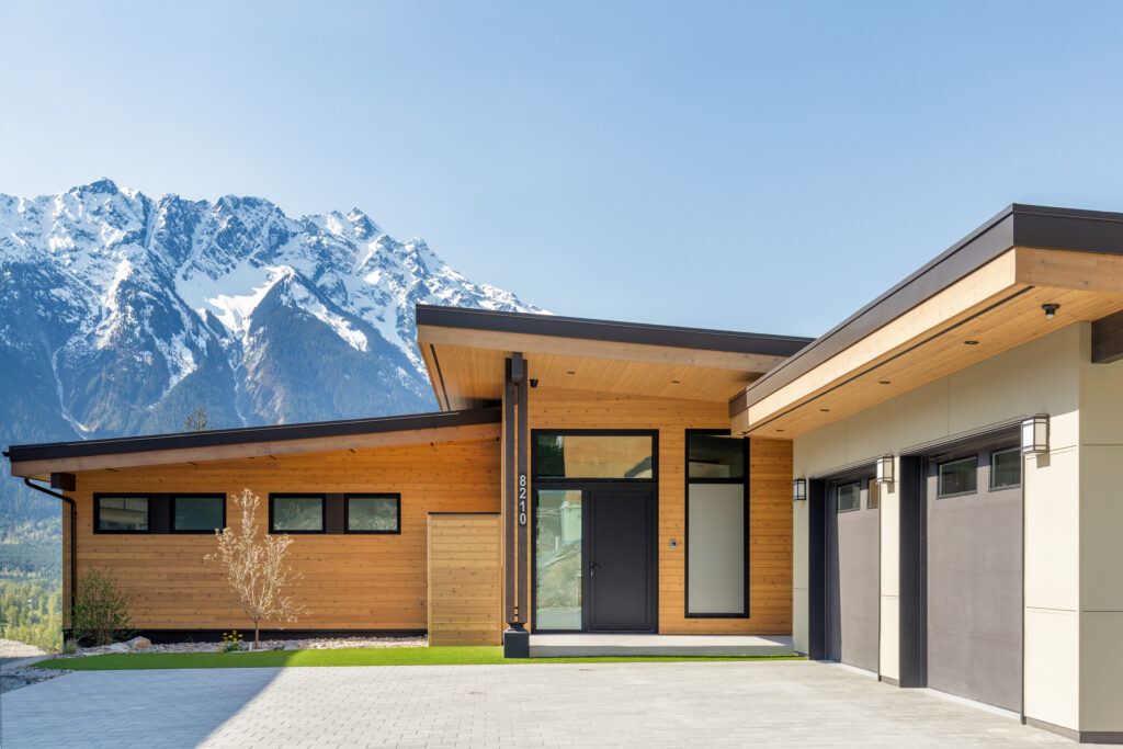 Front view of Merlot Peak home with garage and mountains in Pemberton