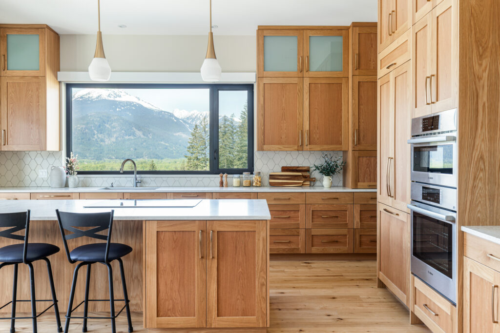 Modern kitchen with wood cabinetry at Merlot Peak Custom Home