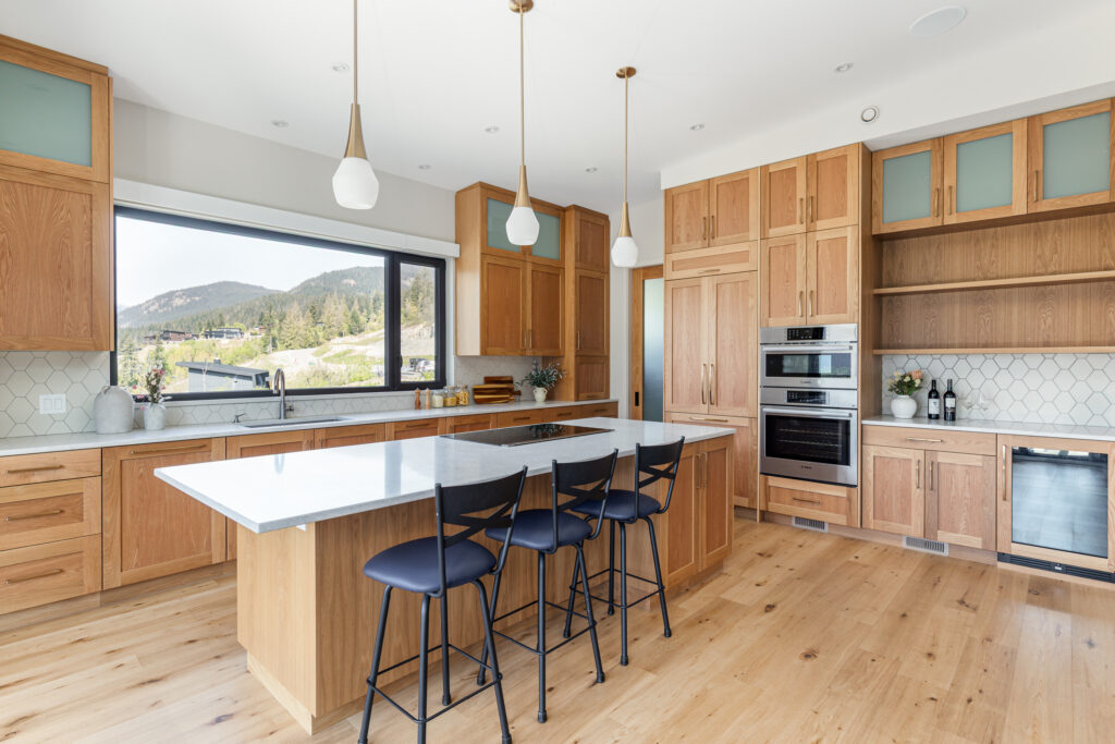 Kitchen island and dining space at Merlot Peak Custom Home