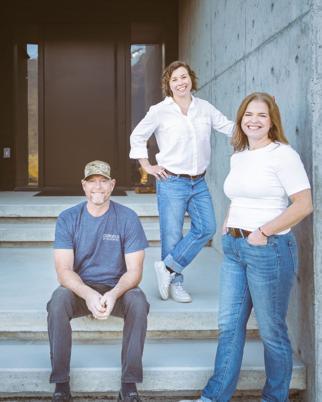 the Dorgelo by design admin team standing in front of a custom home their built in pemberton bc