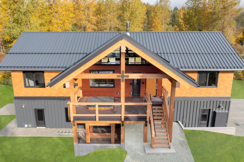 Architectural view highlighting the home’s upper deck and Longboard siding