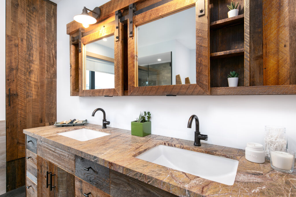 Dual vanity with wood cabinets, black fixtures, and custom mirrors