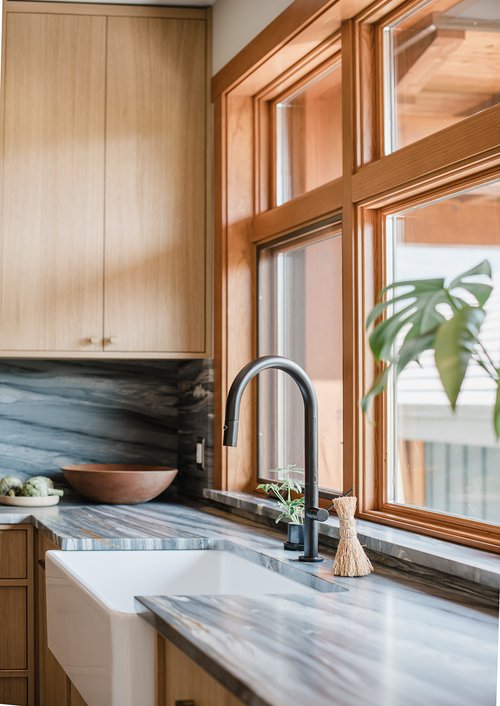 Farmhouse-style sink and full-height windows in Cedar Estates kitchen renovation