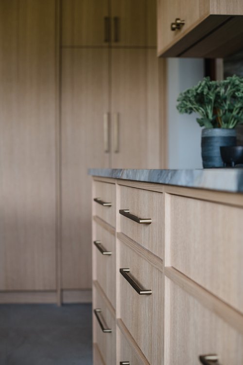Soft-close drawer detail and modern brass handles in Cedar Estates cabinetry
