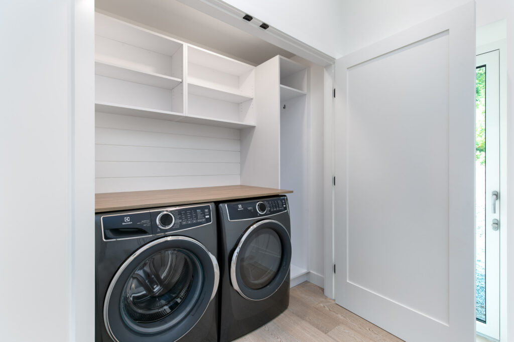 Modern laundry room Modern laundry room with stacked Samsung washer-dryer and built-in cabinetry