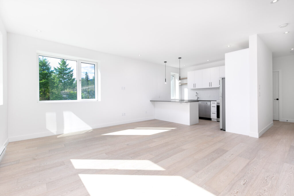 Bright living area Bright living area with light oak flooring, exposed beam ceiling, and matte black fireplace feature