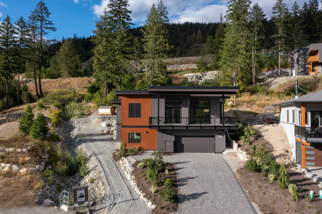 Modern landscape Street-facing view of driveway and modern landscape with raised stone garden beds