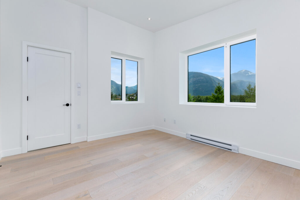 Living area Open-concept living area with gas fireplace, built-in cabinetry, and oversized windows