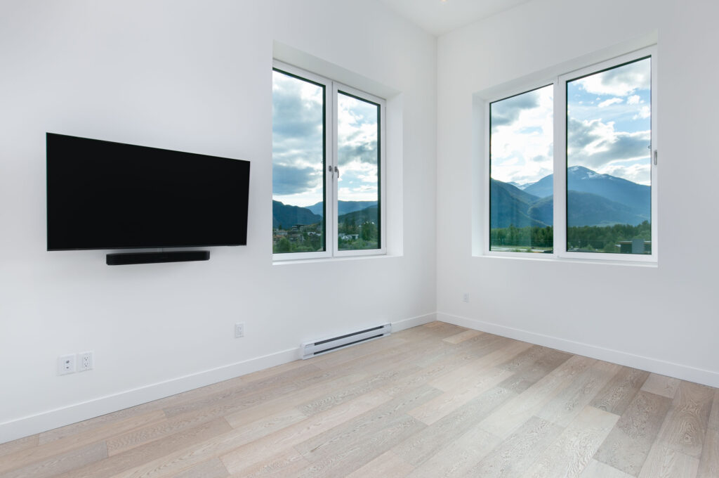 Minimalist bedroom Minimalist bedroom with white walls, large window, and light oak flooring