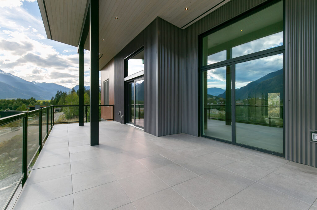 Covered deck Covered deck with glass railing offering unobstructed mountain and forest views