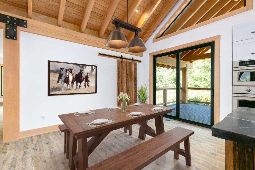 Dining area with exposed beams and access to upper deck