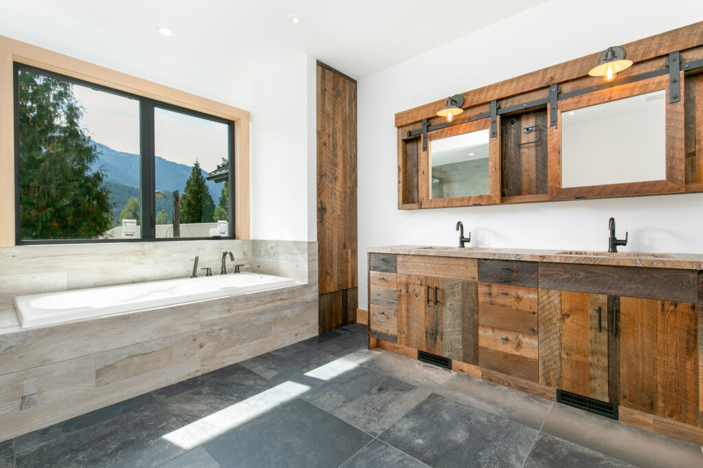 Bright ensuite with soaker tub and large-format porcelain tile