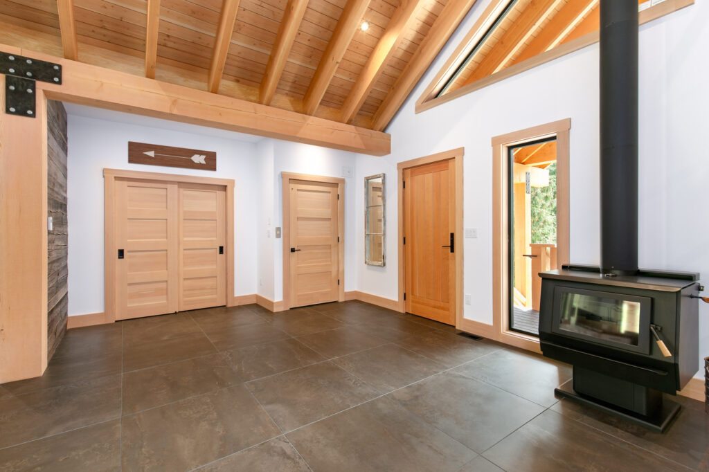 Open foyer with exposed beams and natural wood flooring