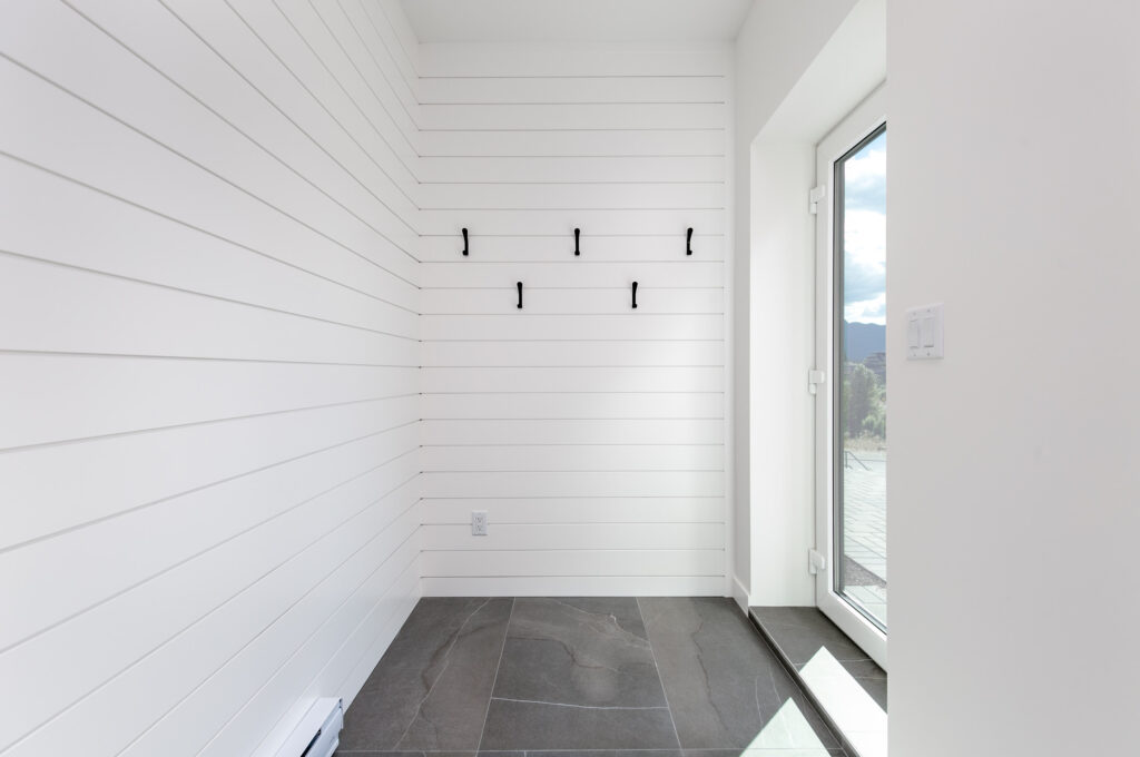 Front Entry Front entryway with large-format tile, black vertical slat wall and built-in bench seating