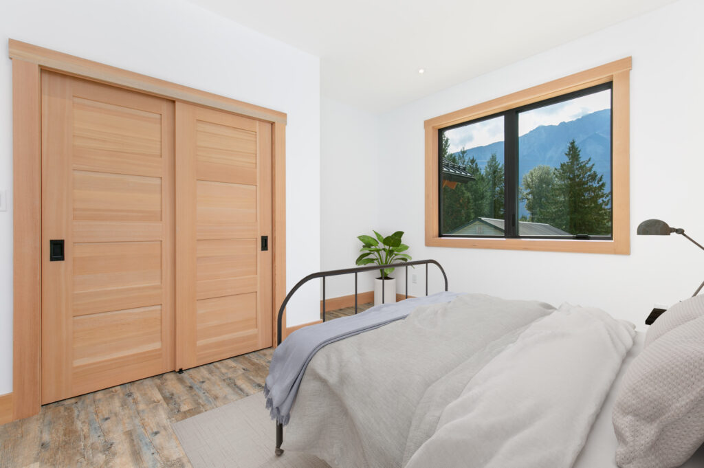 Guest bedroom with large window and Douglas Fir interior doors