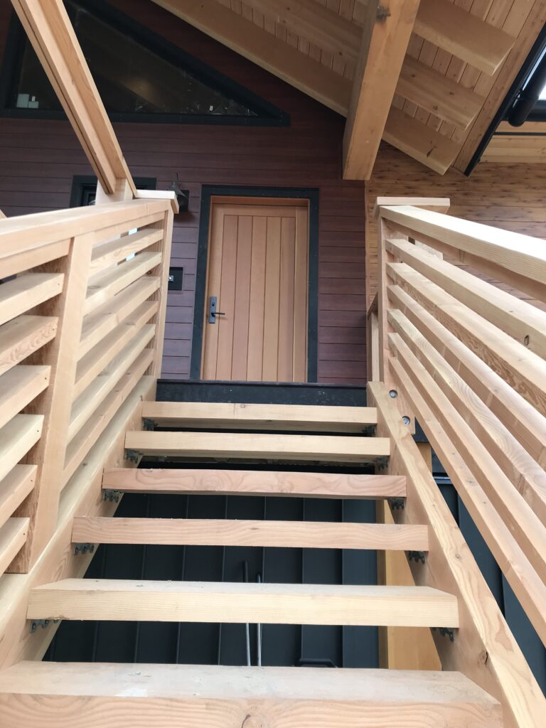 Staircase with solid wood treads and metal railing