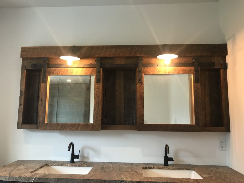 Bathroom vanity with black matte faucet and rustic barnboard texture