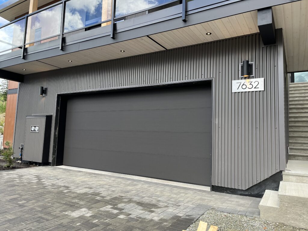 Driveway Angled exterior view showcasing hardscaped driveway and cedar-accented facade