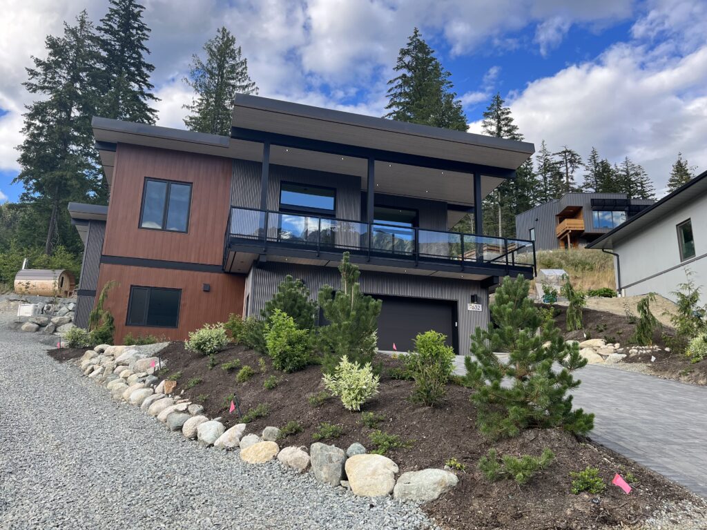 Main home facade View of main home facade with visible Nootka barrel sauna and stone landscaping