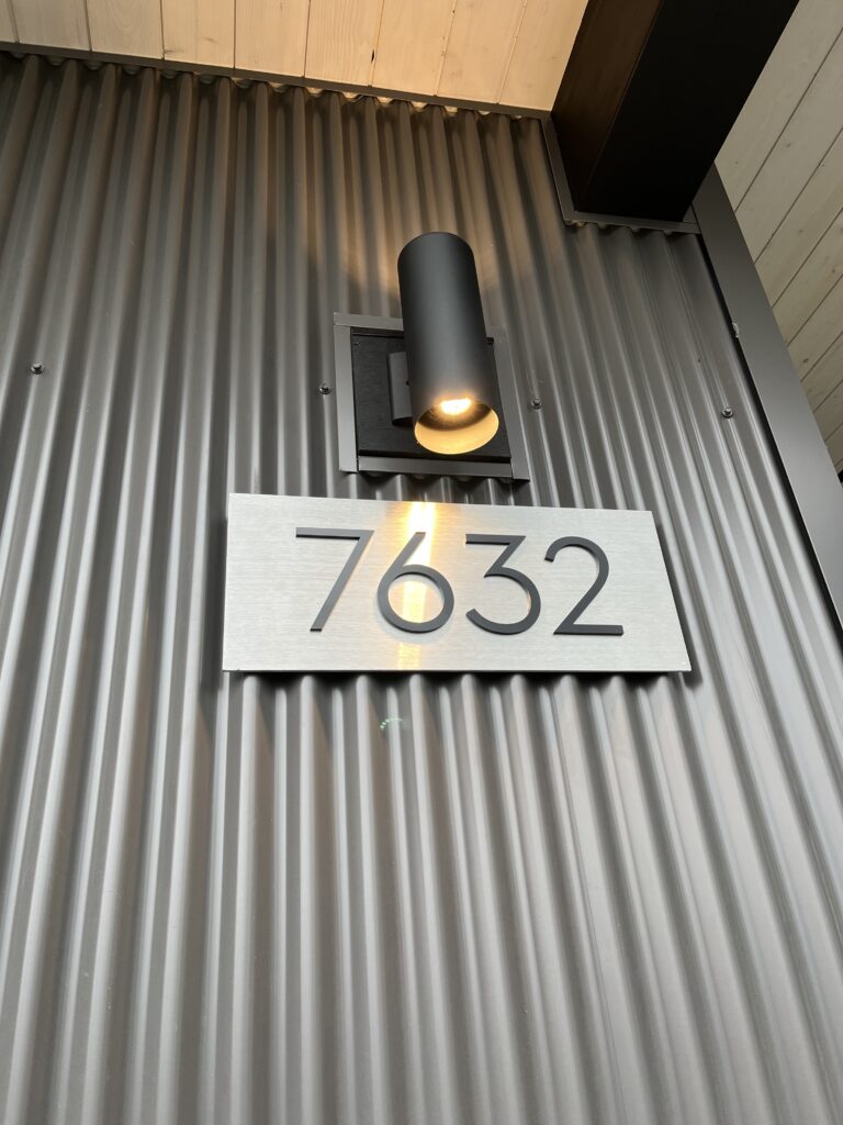 House number plaque Close-up of Kichler outdoor wall light and Easy Digits modern house number plaque