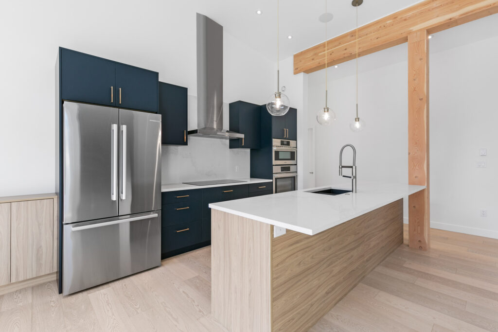 Kitchen Bright kitchen with Honey Carini Walnut island, Caesarstone countertops and Blanco fixtures