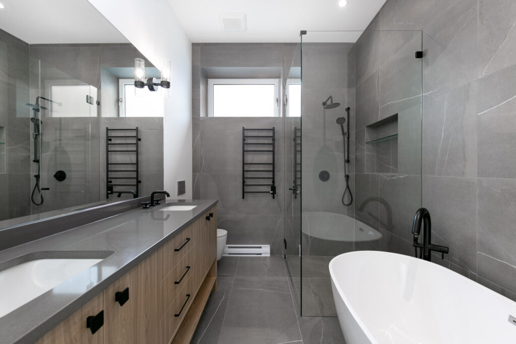 Primary Bathroom Luxury ensuite with floating vanity, freestanding Amber59 tub and matte black Riobel fixtures