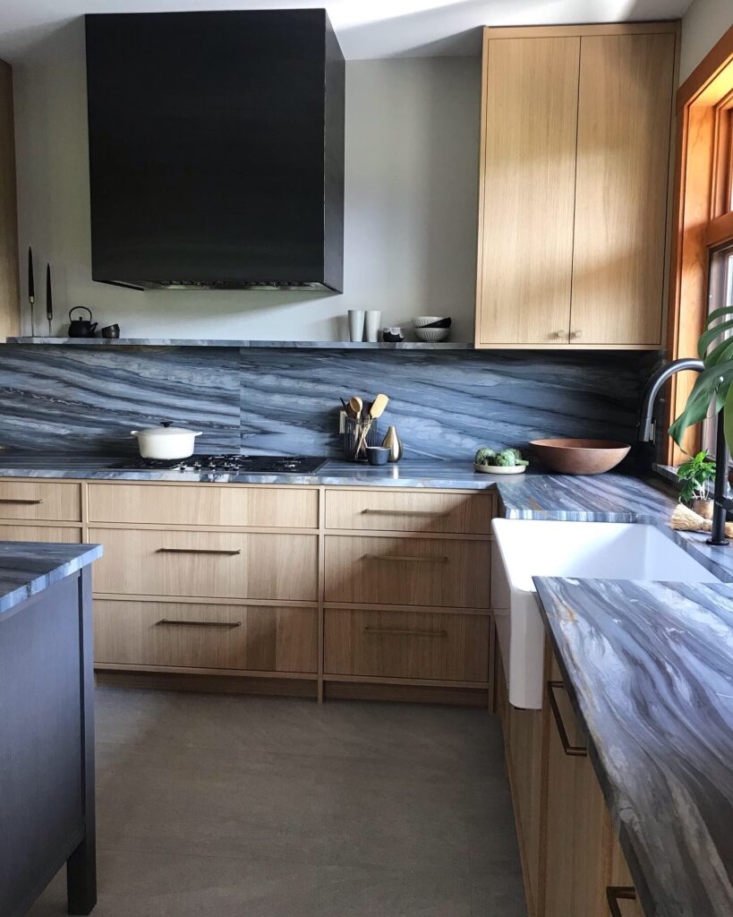 Custom black metal range hood vent and backsplash at Cedar Estates kitchen