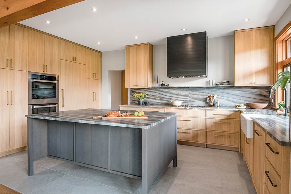 Renovated kitchen with natural oak cabinetry and island at Cedar Estates by Dorgelo