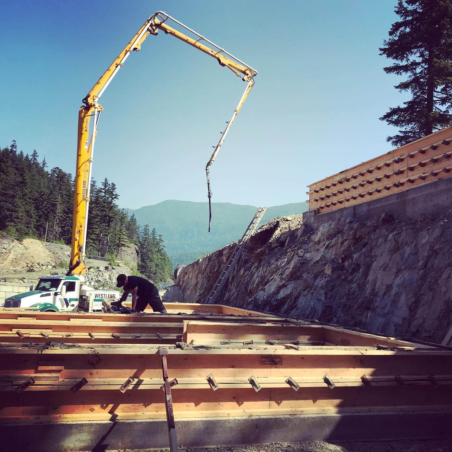 Construction crane working on steep terrain
