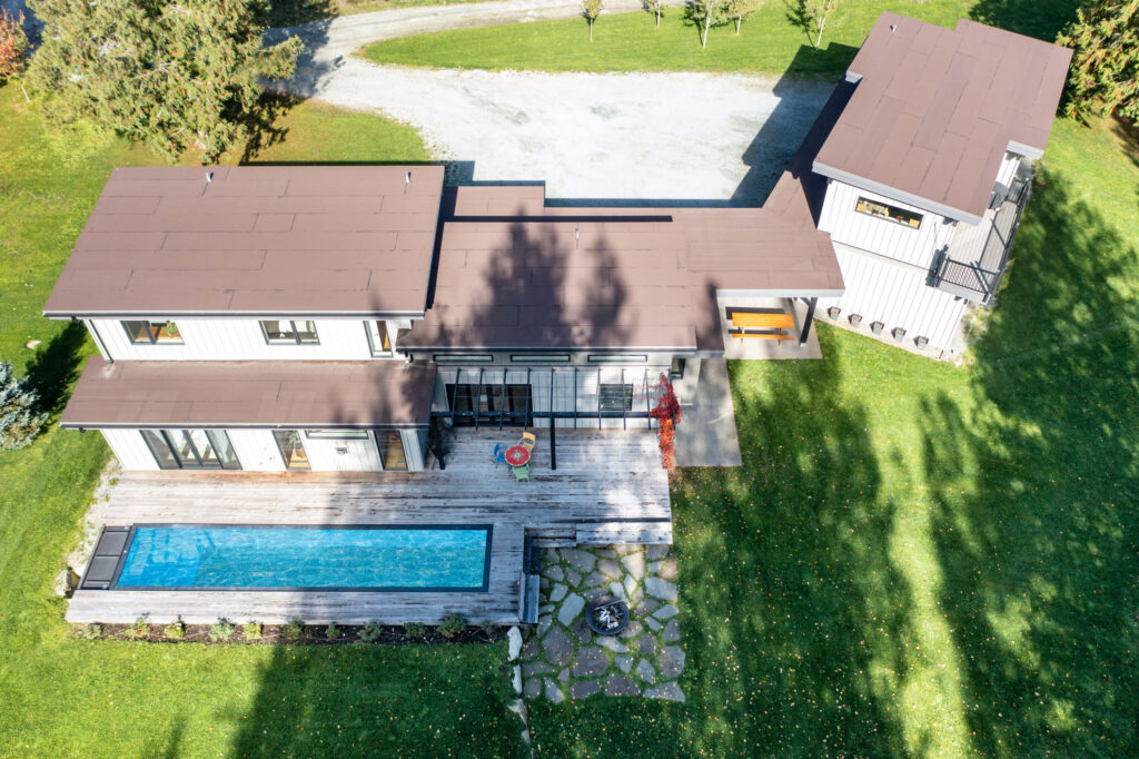 Rear view of house featuring Mod Pool and mountain backdrop
