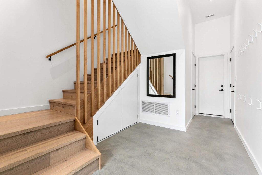 Home foyer with staircase and large mirror