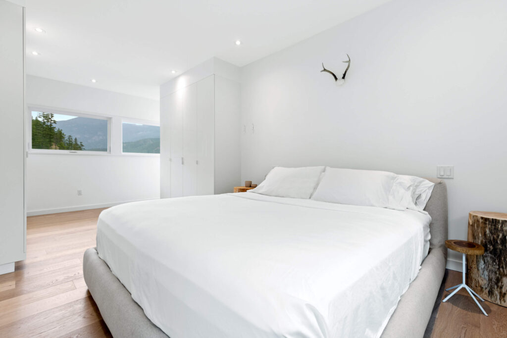 Bright guest bedroom with mountain views