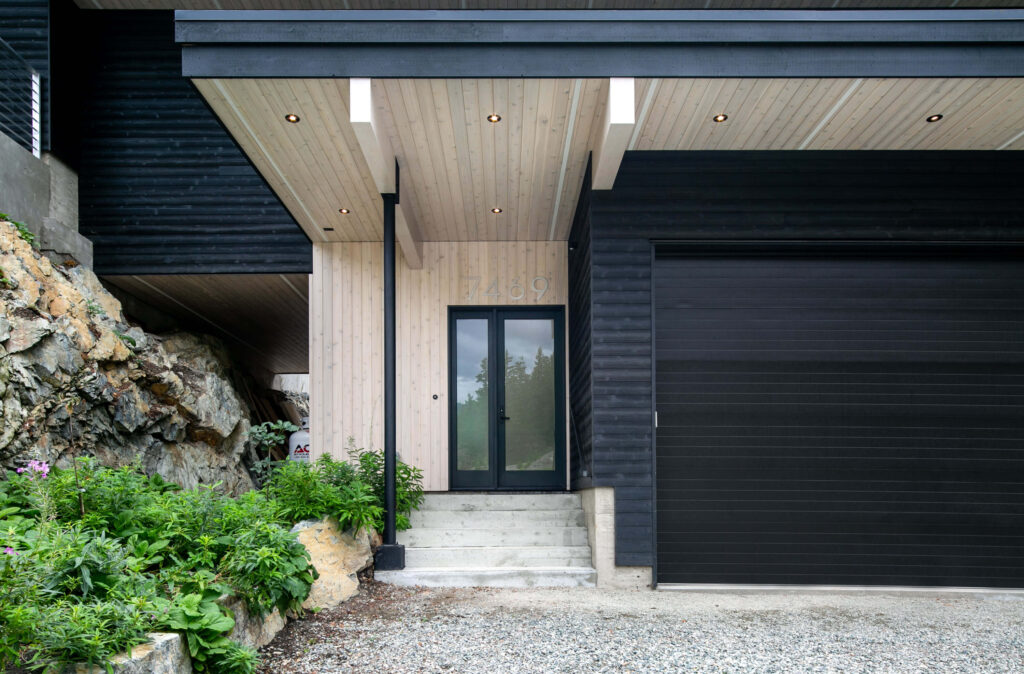 Main entrance with wood ceiling and dark exterior finish