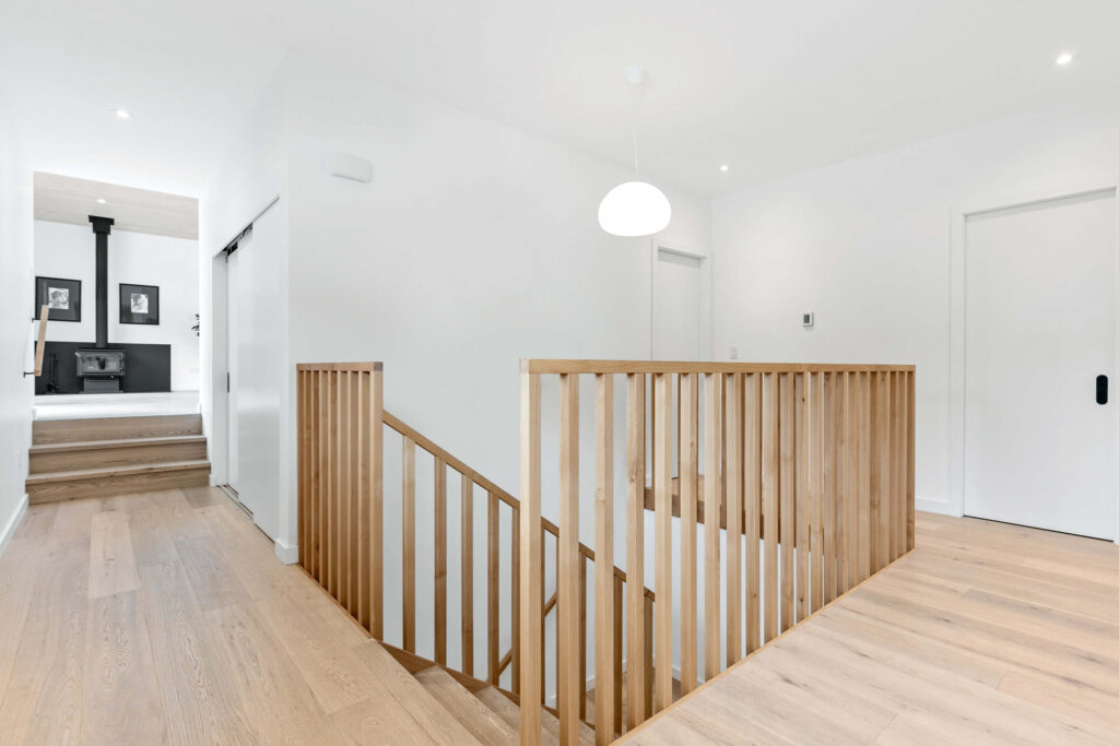 Bright upper floor foyer with wood railing