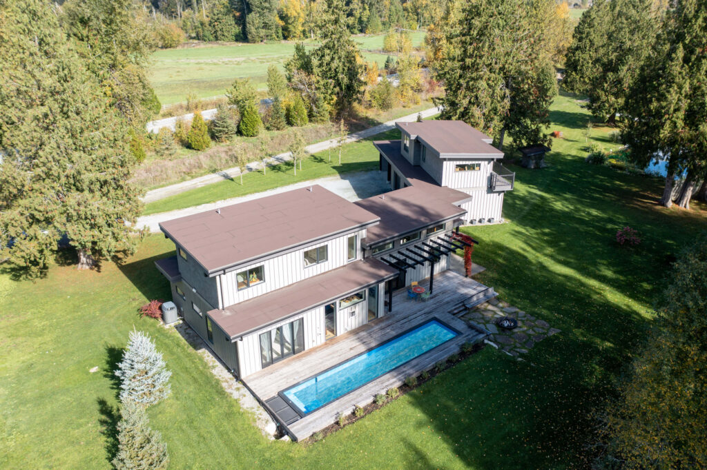 Aerial view of custom home surrounded by trees in Pemberton