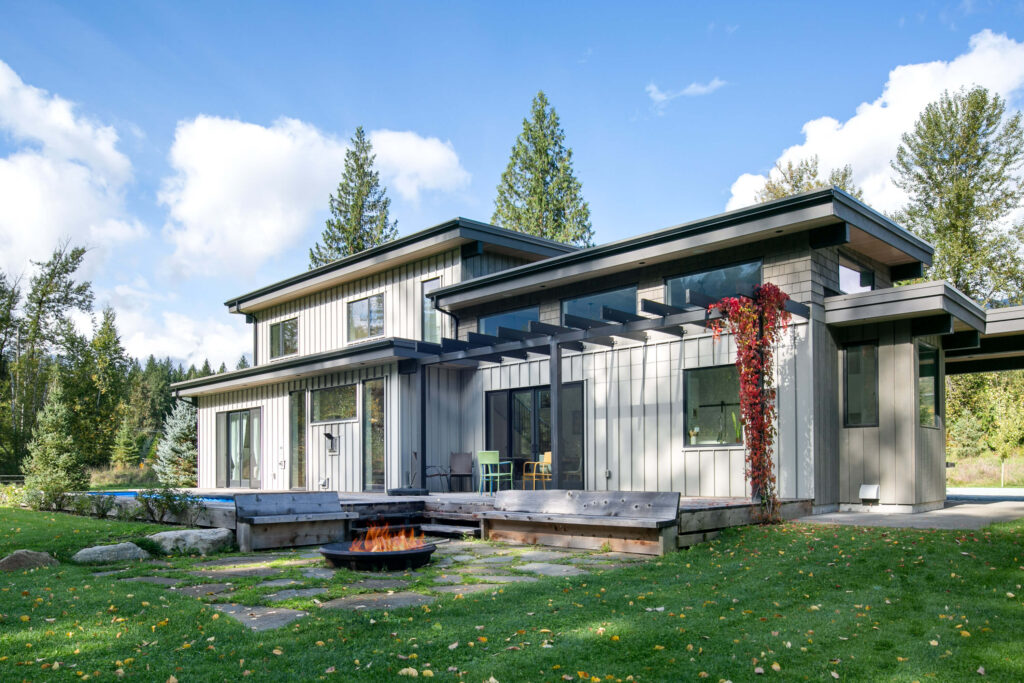 Rear exterior of home with standing seam siding and Mod Pool