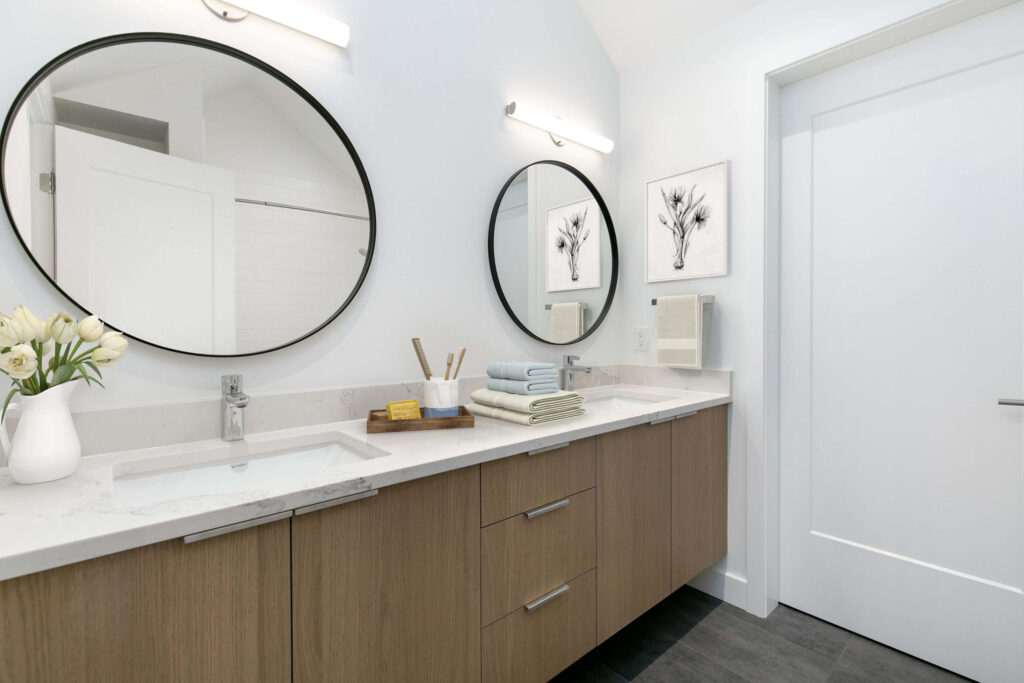 Modern double vanity with round mirrors Bathroom with dual sinks and modern round mirrors