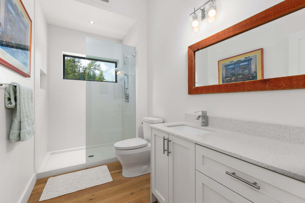 White modern bathroom with integrated vanity and large mirror