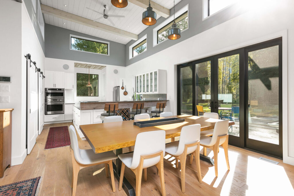 Dining area with vaulted ceilings and access to outdoor patio