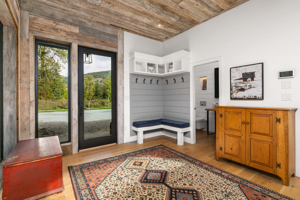 Entryway interior with barnboard ceiling and seating nook