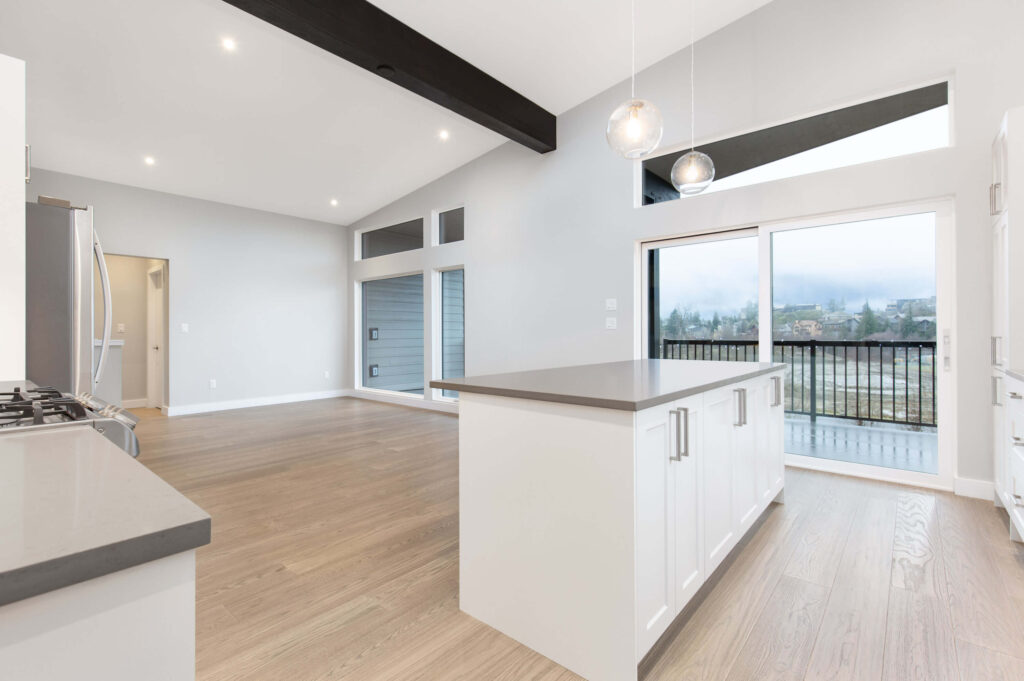 Kitchen with appliances Compact kitchen with stainless steel appliances and pendant lights